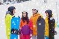 Happy friends in helmets with snowboards talking Royalty Free Stock Photo