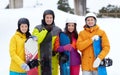 Happy friends in helmets with snowboards Royalty Free Stock Photo