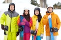 Happy friends in helmets with snowboards Royalty Free Stock Photo