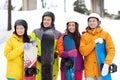 Happy friends in helmets with snowboards Royalty Free Stock Photo