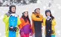 Happy friends in helmets with snowboards Royalty Free Stock Photo