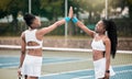Happy friends high five on the tennis court. Two professional tennis players motivate each other after a match. African