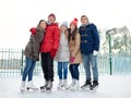 Happy friends ice skating on rink outdoors Royalty Free Stock Photo