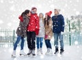 Happy friends ice skating on rink outdoors Royalty Free Stock Photo