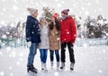 Happy friends ice skating on rink outdoors Royalty Free Stock Photo