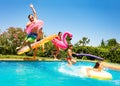 Happy friends jumping in pool on the vacations Royalty Free Stock Photo
