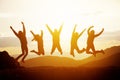 Happy friends jumping sunset mountains Royalty Free Stock Photo