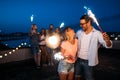 Happy friends lighting sparklers and enjoying freedom Royalty Free Stock Photo