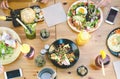 Happy friends lunching with healthy food in bar coffee brunch - Top view young people having meal eating and drinking smoothies Royalty Free Stock Photo