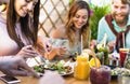 Happy friends lunching with healthy food in bar coffee brunch - Young people having fun eating meal and drinking fresh smoothies Royalty Free Stock Photo