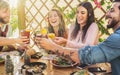 Happy friends lunching healthy food and drinking smoothies fresh fruits - Young people having fun eating Royalty Free Stock Photo