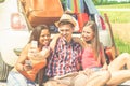 Happy friends making selfie photo standing next car full of suitcases and bags - Young people having fun in road trip holidays - Royalty Free Stock Photo