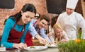 Happy friends and male chef cooking in kitchen Royalty Free Stock Photo