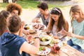 Happy friends in the park having lunch Royalty Free Stock Photo