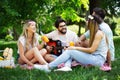 Happy friends in the park having picnic on a sunny day. Royalty Free Stock Photo