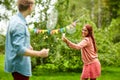 Happy friends playing badminton at summer garden Royalty Free Stock Photo