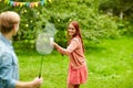 Happy friends playing badminton at summer garden Royalty Free Stock Photo