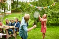 Happy friends playing badminton at summer garden Royalty Free Stock Photo