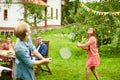Happy friends playing badminton at summer garden Royalty Free Stock Photo