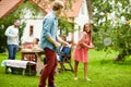 Happy friends playing badminton at summer garden Royalty Free Stock Photo