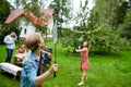 Happy friends playing badminton at summer garden Royalty Free Stock Photo