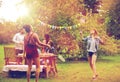 Happy friends playing badminton at summer garden Royalty Free Stock Photo