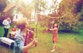 Happy friends playing badminton at summer garden Royalty Free Stock Photo