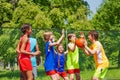 Happy friends playing basketball game outside