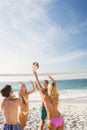 Happy friends playing beach volleyball Royalty Free Stock Photo