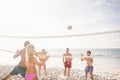 Happy friends playing beach volleyball Royalty Free Stock Photo