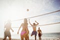 Happy friends playing beach volleyball Royalty Free Stock Photo