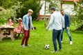 Happy friends playing football at summer garden Royalty Free Stock Photo