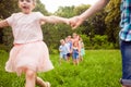 Happy friends playing outdoors game on birthday party in summer park Royalty Free Stock Photo