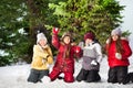 Happy friends playing snowballs at winter forest Royalty Free Stock Photo