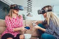 Happy friends playing video games with virtual reality glasses Royalty Free Stock Photo