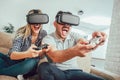 Happy friends playing video games with virtual reality glasses Royalty Free Stock Photo