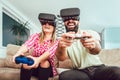 Happy friends playing video games with virtual reality glasses Royalty Free Stock Photo