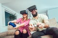 Happy friends playing video games with virtual reality glasses Royalty Free Stock Photo