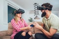 Happy friends playing video games with virtual reality glasses Royalty Free Stock Photo