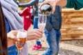 Happy friends pouring champagne sparkling wine into glasses outdoors. Sunset party. Royalty Free Stock Photo