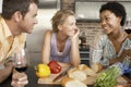 Happy Friends With Preparing Food At Kitchen Counter