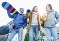 Happy friends ready for a sporty ski day in alps mountains at sunrise - Young cheerful people for a snow weekend with back sun Royalty Free Stock Photo