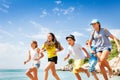 Happy friends running on summer beach Royalty Free Stock Photo