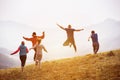 Happy friends runs and jumps outdoors Royalty Free Stock Photo