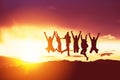Happy friends silhouettes jumps sunset Royalty Free Stock Photo