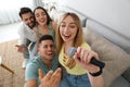 Happy friends singing karaoke together at home Royalty Free Stock Photo