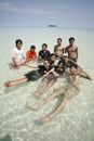 Happy friends sitting at the beautifull beach