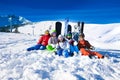 Happy friends sitting with snowboards and skis Royalty Free Stock Photo