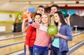 Happy friends with smartphone in bowling club Royalty Free Stock Photo