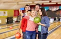 Happy friends with smartphone in bowling club Royalty Free Stock Photo